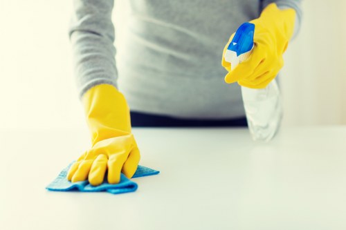 Professional cleaner maintaining a bright corporate meeting room